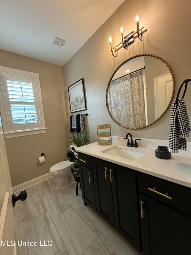 bathroom with toilet and vanity