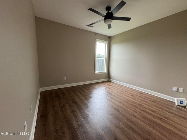 unfurnished room with ceiling fan and dark hardwood / wood-style flooring