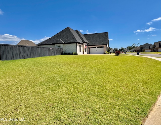 view of home's exterior featuring a lawn and a garage