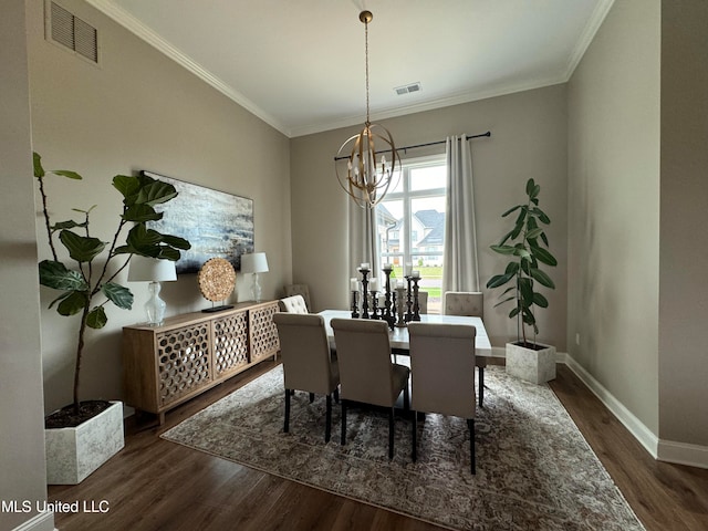 dining room featuring ornamental molding, a chandelier, and dark hardwood / wood-style flooring