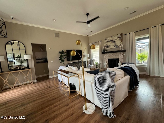 living room featuring ceiling fan, crown molding, a wealth of natural light, and dark hardwood / wood-style floors