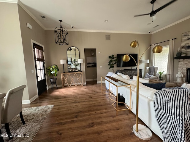 living room featuring a fireplace, ornamental molding, plenty of natural light, and dark hardwood / wood-style floors