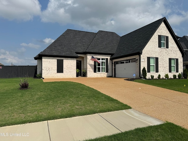 view of front of home featuring a front lawn and a garage