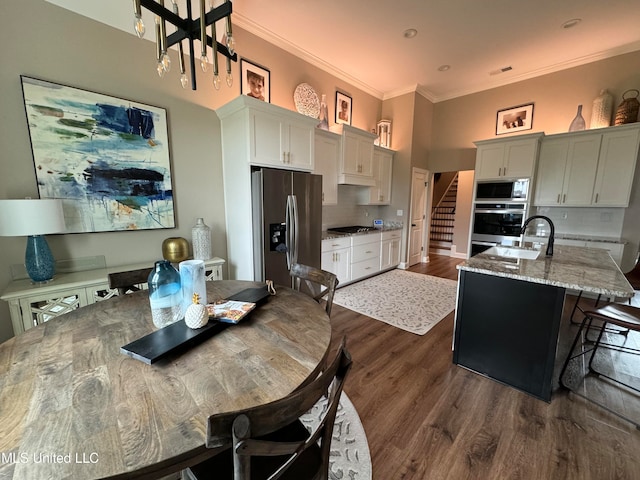 kitchen with light stone countertops, sink, appliances with stainless steel finishes, and backsplash