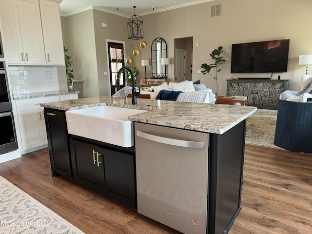 kitchen with white cabinets, a kitchen island with sink, stainless steel dishwasher, and sink