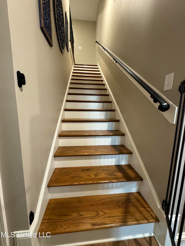 stairway featuring wood-type flooring