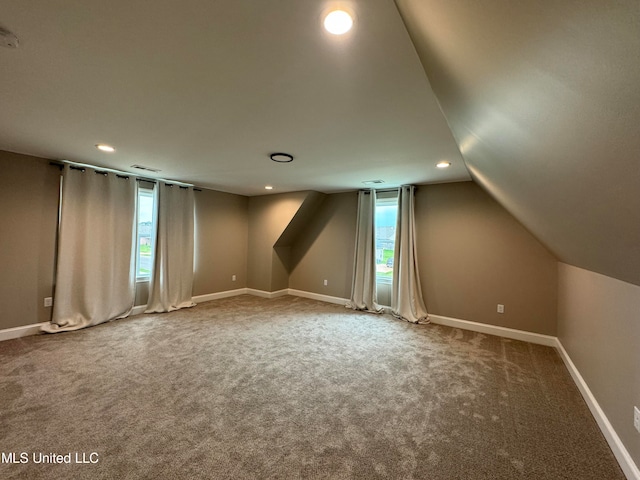 bonus room featuring lofted ceiling, a wealth of natural light, and carpet floors