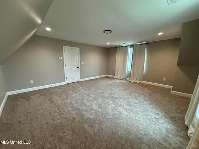 interior space featuring lofted ceiling and carpet flooring