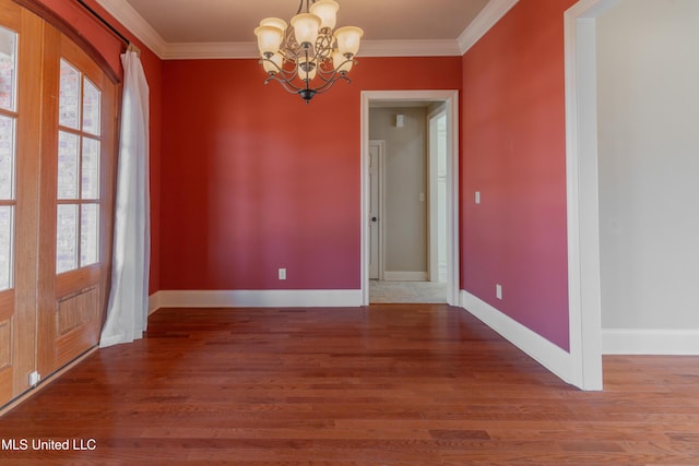 unfurnished dining area featuring an inviting chandelier, hardwood / wood-style flooring, and ornamental molding