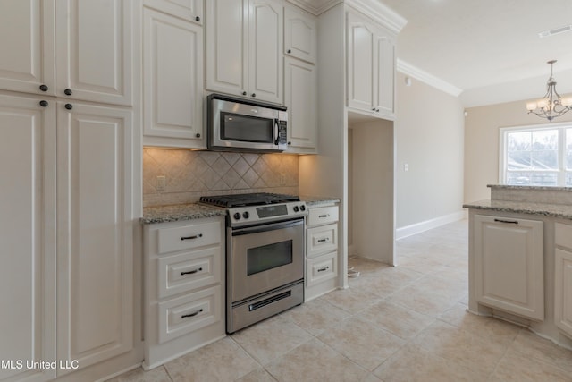 kitchen with white cabinetry, pendant lighting, light stone countertops, and appliances with stainless steel finishes