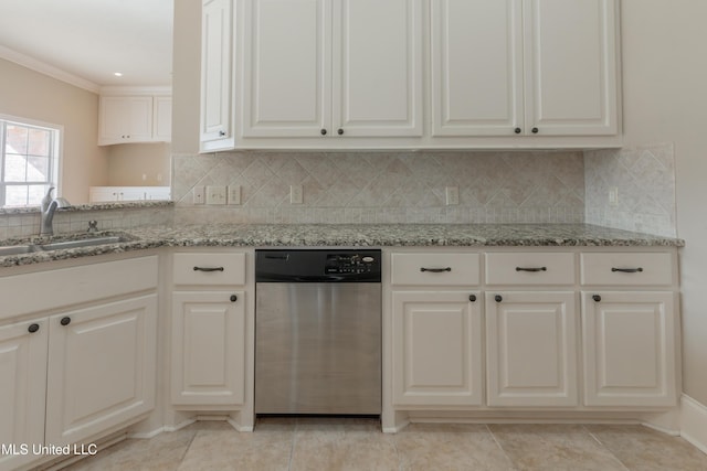 kitchen with sink, tasteful backsplash, stainless steel dishwasher, light stone countertops, and white cabinets