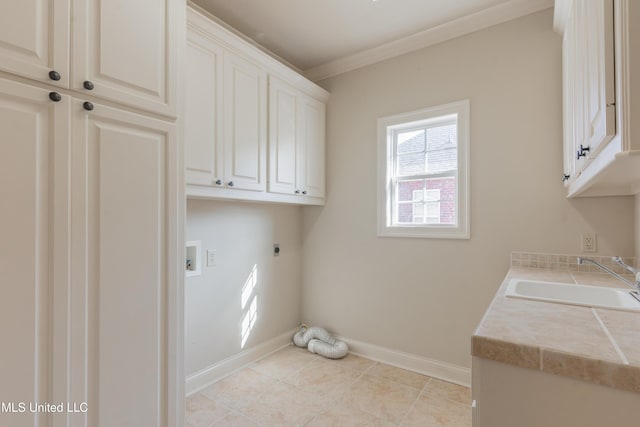 washroom featuring sink, cabinets, ornamental molding, electric dryer hookup, and washer hookup