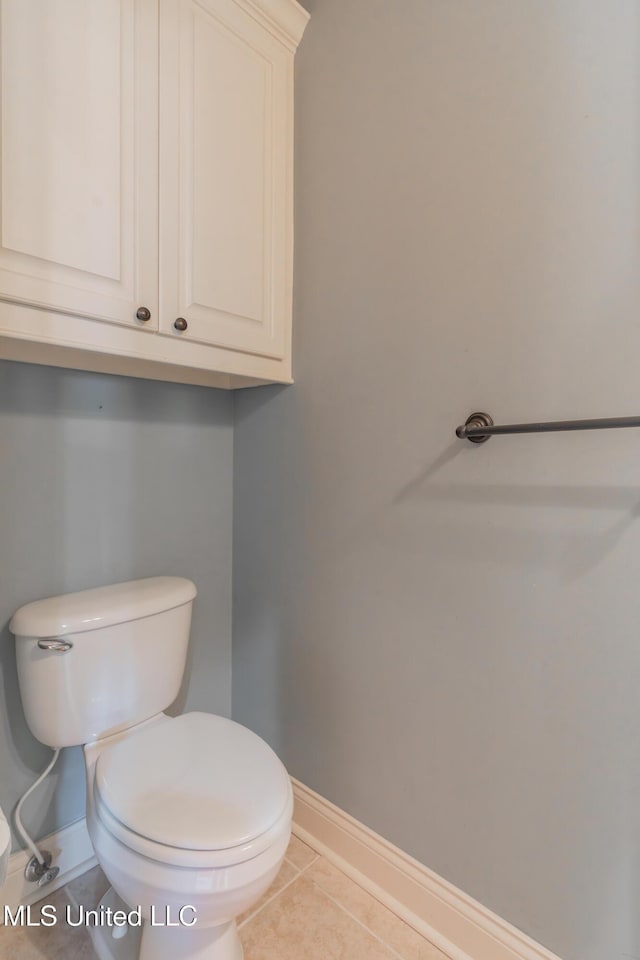 bathroom with tile patterned flooring and toilet