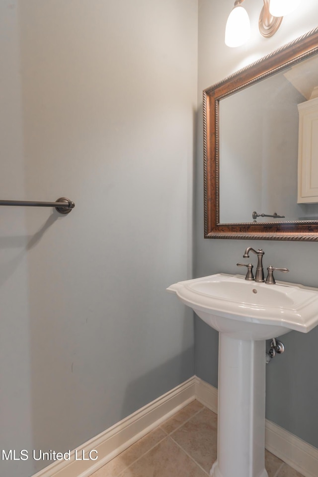 bathroom with sink and tile patterned flooring