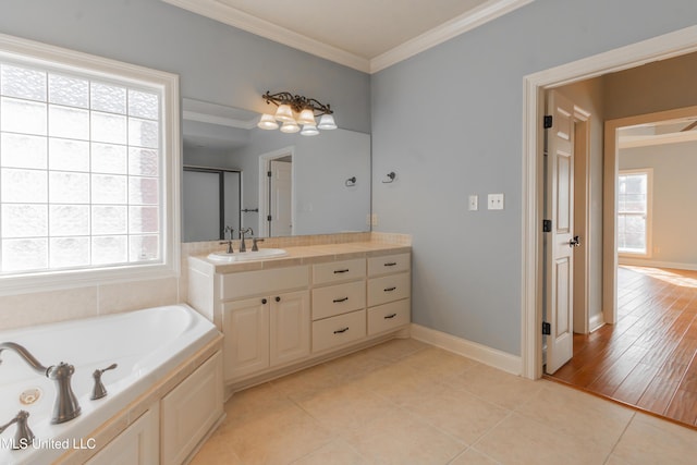 bathroom with vanity, a wealth of natural light, and ornamental molding