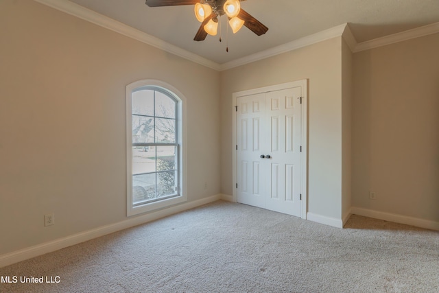 unfurnished bedroom with light carpet, crown molding, a closet, and ceiling fan