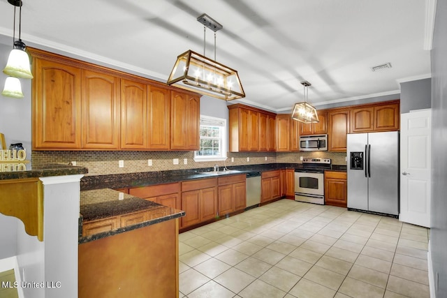 kitchen with visible vents, a sink, tasteful backsplash, appliances with stainless steel finishes, and brown cabinetry