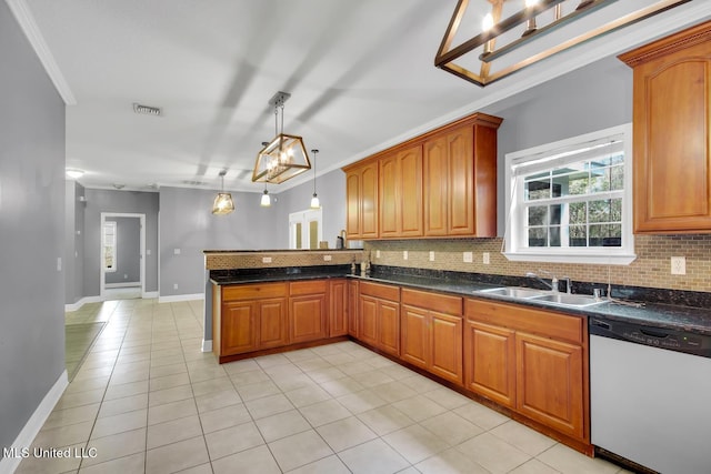 kitchen featuring brown cabinetry, a peninsula, a sink, dishwasher, and backsplash