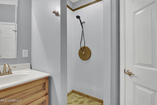 bathroom featuring vanity, tile patterned floors, and baseboards