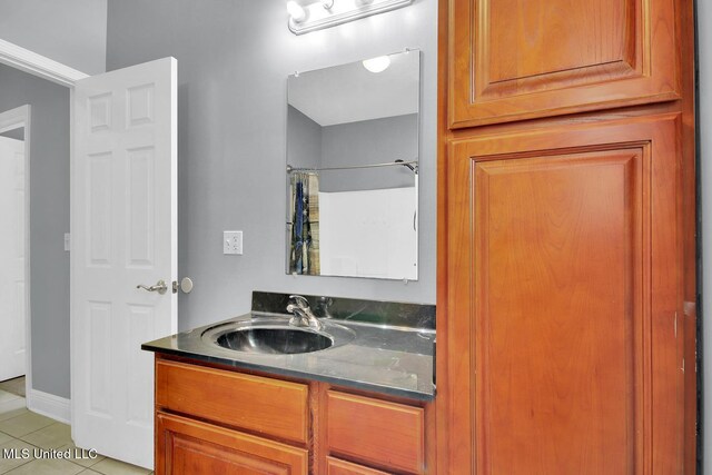 bathroom with tile patterned floors, curtained shower, and vanity