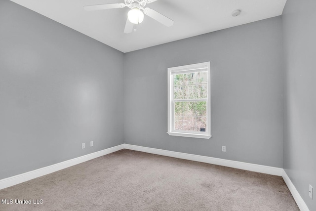 empty room featuring carpet flooring, a ceiling fan, and baseboards