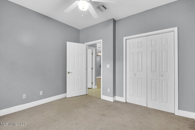 unfurnished bedroom featuring a closet, baseboards, visible vents, and carpet floors