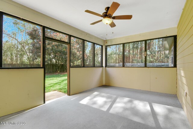 unfurnished sunroom with a ceiling fan