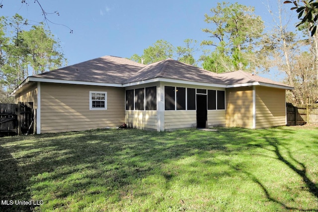 back of house with a sunroom, a yard, and fence