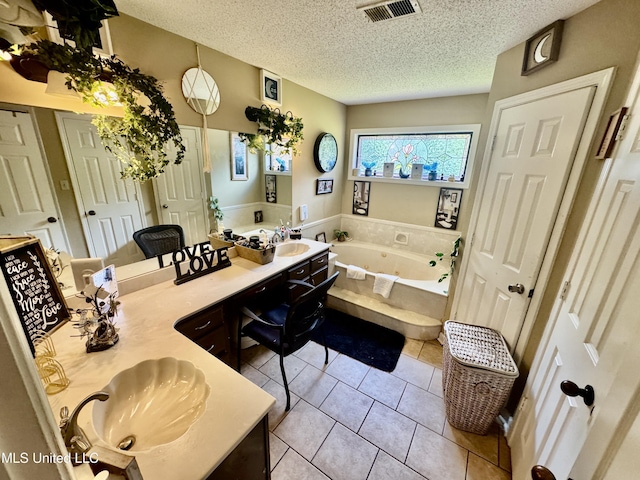 7264 Flower Creek Dr, Southaven, MS 38671 - full bathroom featuring double vanity, a tub with jets, tile patterned floors, and a textured ceiling