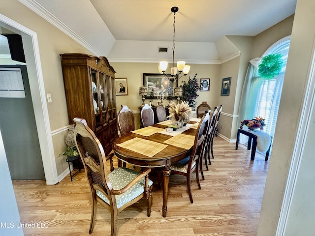 7264 Flower Creek Dr, Southaven, MS 38671 - dining area with a chandelier, light wood-style flooring, and vaulted ceiling