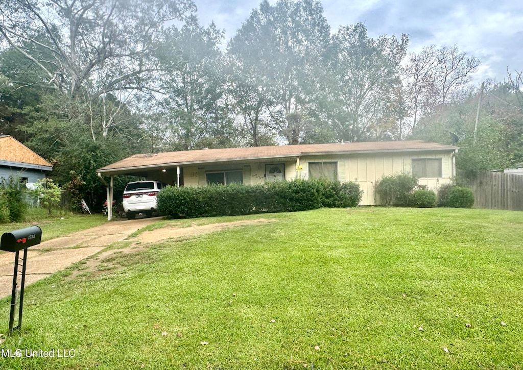 view of front facade with a carport and a front yard