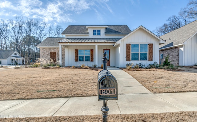 601 Cobalt Way, Brandon, MS 39042 - view of front facade with board and batten siding, a standing seam roof, roof with shingles, and metal roof