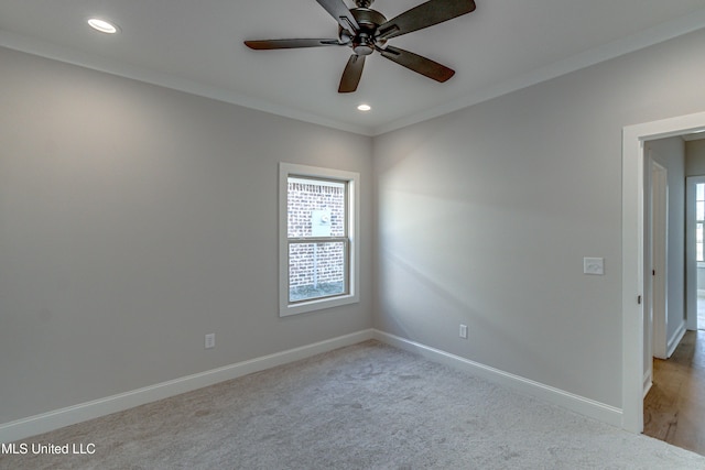 unfurnished room featuring ceiling fan, crown molding, and light carpet