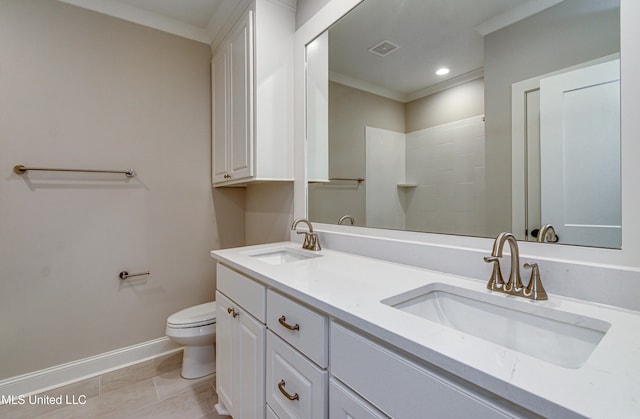 bathroom featuring toilet, vanity, ornamental molding, and tile patterned flooring