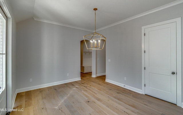 unfurnished dining area featuring crown molding, light hardwood / wood-style flooring, lofted ceiling, and a chandelier