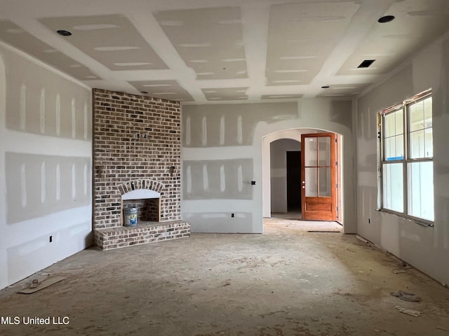 unfurnished living room featuring a brick fireplace