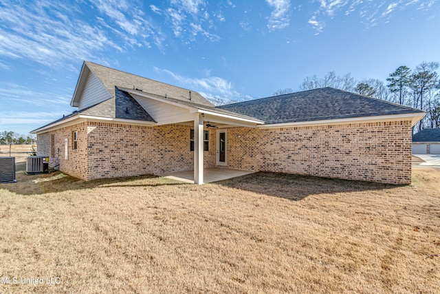 rear view of property featuring ceiling fan, central AC unit, a lawn, and a patio