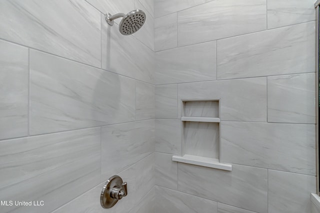 bathroom with tiled shower