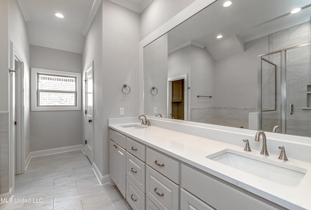 bathroom with vanity and a shower with door