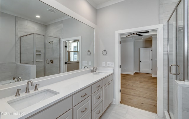 bathroom with ornamental molding, a shower with door, tile patterned flooring, and vanity