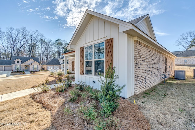 601 Cobalt Way, Brandon, MS 39042 - view of side of property featuring board and batten siding, brick siding, and central AC unit