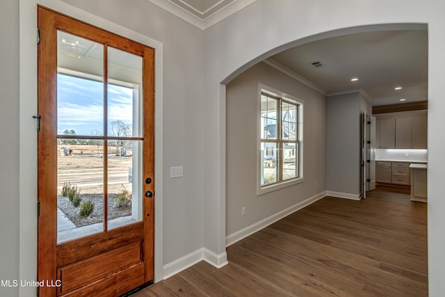 foyer with crown molding and dark hardwood / wood-style floors