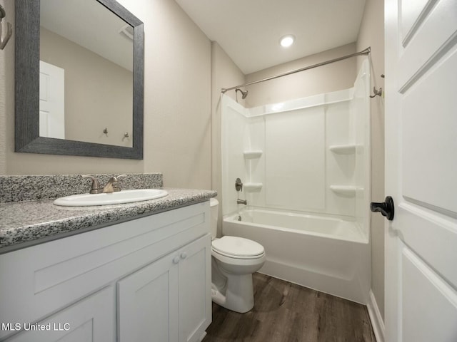 bathroom featuring shower / bath combination, toilet, wood finished floors, and vanity