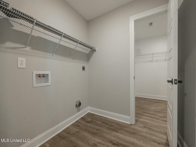 laundry room with hookup for an electric dryer, laundry area, washer hookup, wood finished floors, and baseboards