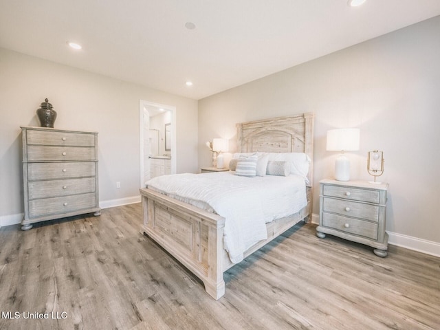 bedroom featuring recessed lighting, ensuite bath, light wood-style flooring, and baseboards