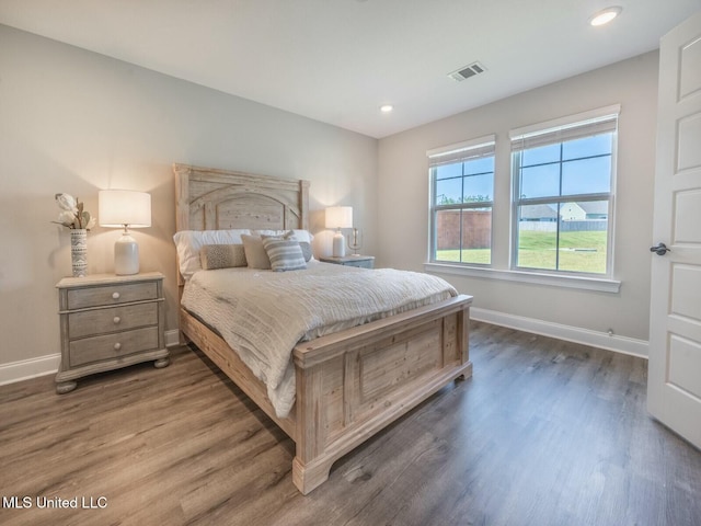 bedroom featuring recessed lighting, dark wood-style flooring, visible vents, and baseboards