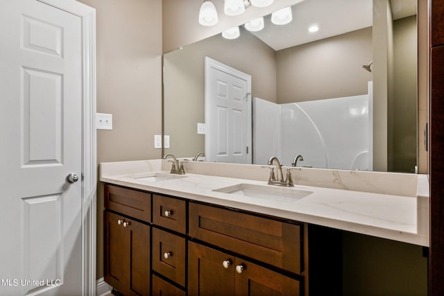 full bath featuring double vanity and a sink