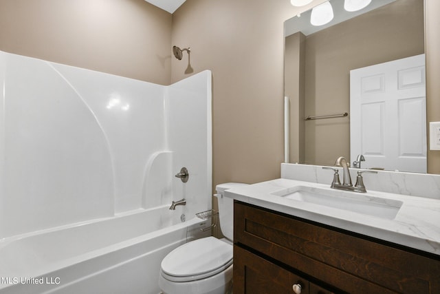 bathroom featuring washtub / shower combination, vanity, and toilet