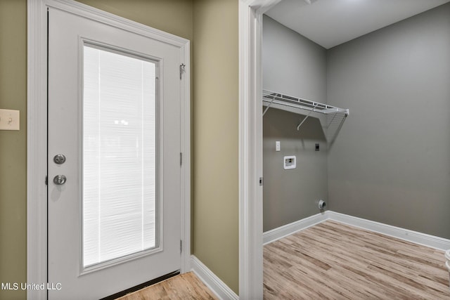 laundry area with hookup for an electric dryer, light wood-style floors, washer hookup, laundry area, and baseboards