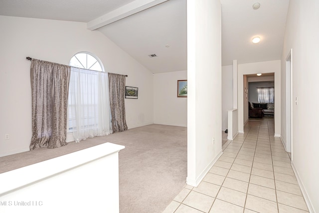 hall with light colored carpet and lofted ceiling with beams